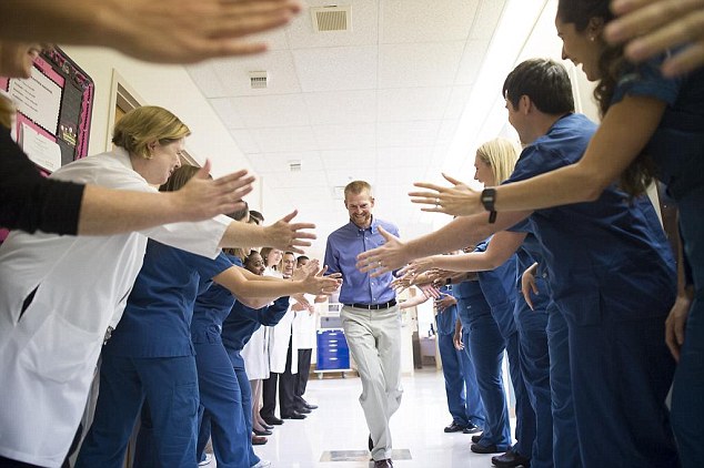 Thank you: Dr Kent Brantly high-fives the medical team at Emory University, as he was released from the hospital on Thursday
