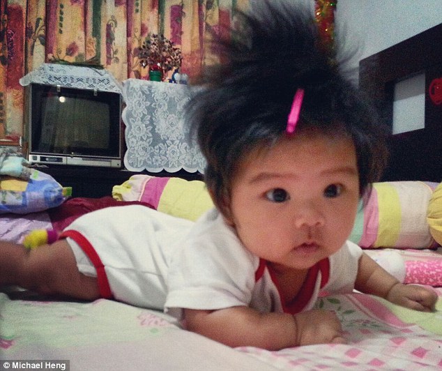 Michael Heng sent in this picture of his adorable daughter who has to wear a clip to keep her crazy hair in place