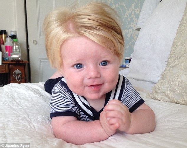 Little Freddie, pictured at five-months-old, was born with dark hair, but it has turned blond and he now looks as though he