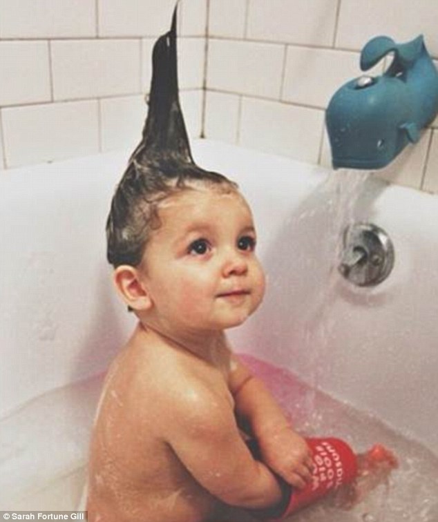 Sarah Fortune Gill shared this adorable picture of her baby playing with a bucket at bath time 
